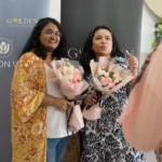 Malay woman and indian woman holding flower bouquet while smiling to the camera, flower arrangement class