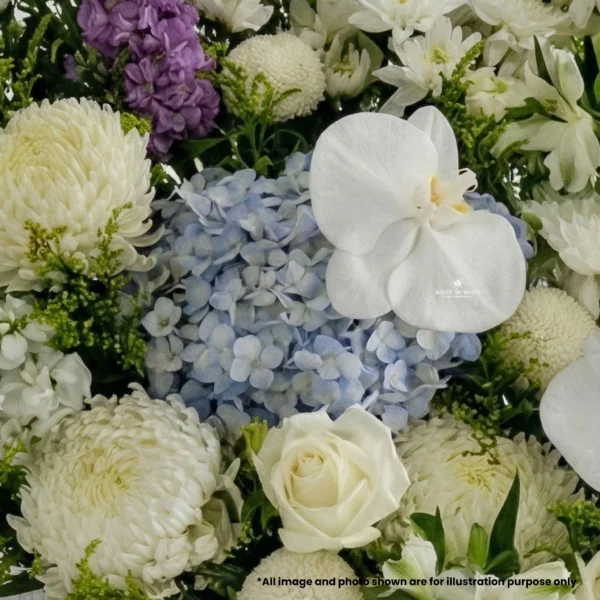 Grand funeral flower stand featuring Purple Matthiola and Blue Hydrangea with White Orchids by White On White
