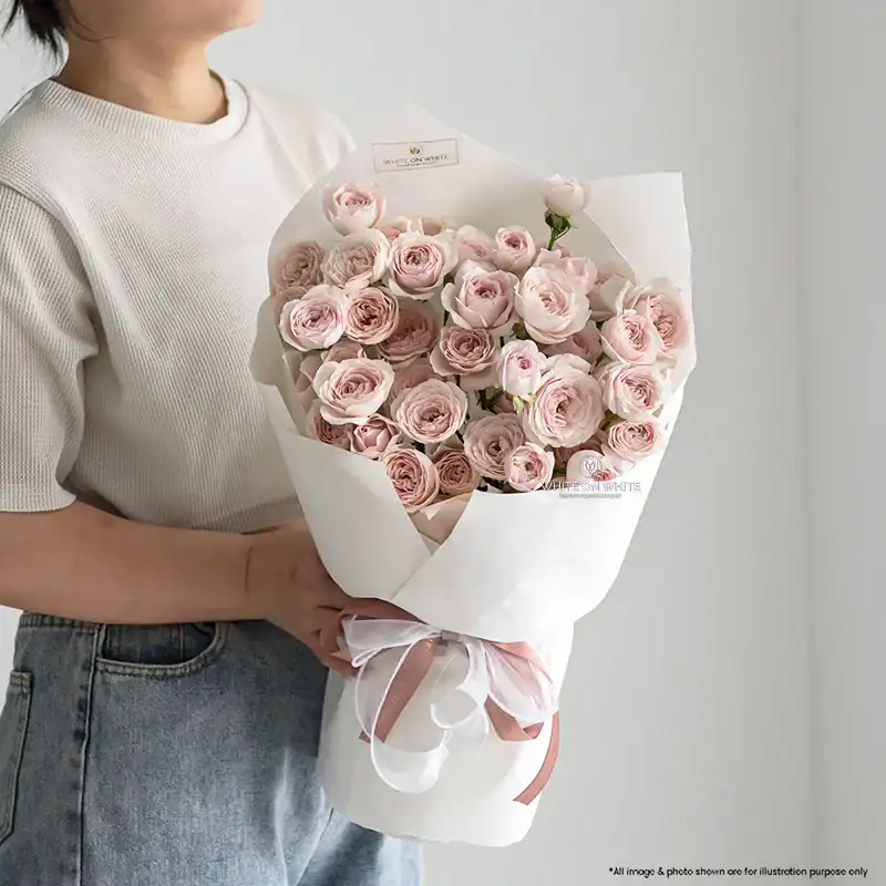 Fairy's Kiss Bouquet featuring pale pink Fairy's Kiss Rosespray wrapped in white paper, available for same day delivery Singapore